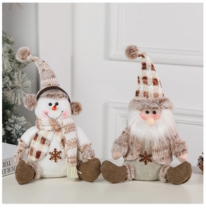 Detail of Christmas snowman and gnome plush dolls with plaid hats and knit scarves