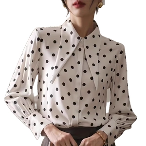 Detailed view of polka dot shirt featuring retro pointed collar and elegant lantern sleeves
