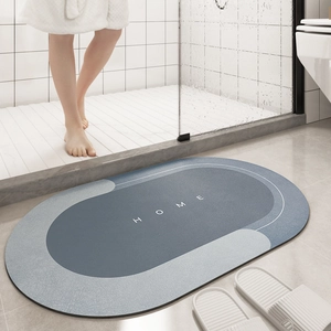 Detailed close-up of blue-grey oval non-slip bathroom mat with HOME text pattern