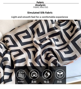 Detail of silk-like scarf fabric with black geometric pattern and smooth texture