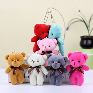 Close-up of seven colorful teddy bear plush pendants with Love ribbons and metal chains