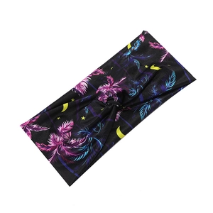 Detail view of black sweatband with colorful feather and moon patterns for fitness