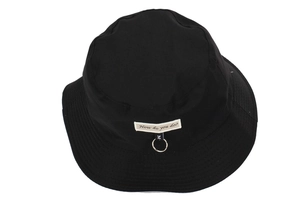 Detailed shot of black cotton bucket hat featuring embroidered label and silver metal ring