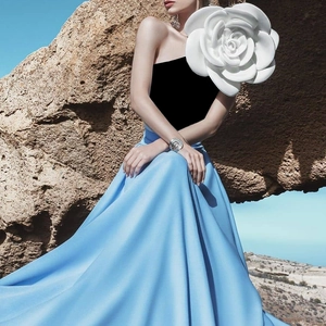 Detail of elegant 3D white rose shoulder design on stylish backless evening dress