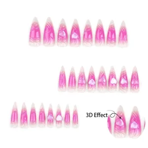 Pink gradient long stiletto fake nails with 3D glitter heart accents and marble patterns