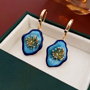 Vintage irregular flower earrings with blue enamel and zircon in a luxury jewelry box