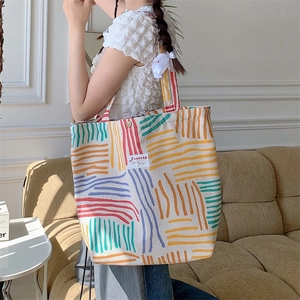 Detail showing colorful stripe pattern and texture on corduroy canvas tote bag