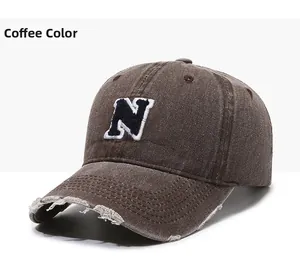 Detail of coffee brown baseball cap with embroidered N logo and vintage frayed brim