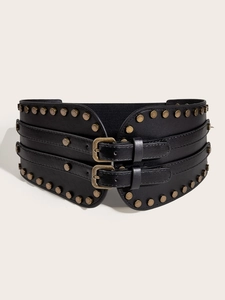 Detail of black leather corset belt with vintage metal rivets and double buckle closure