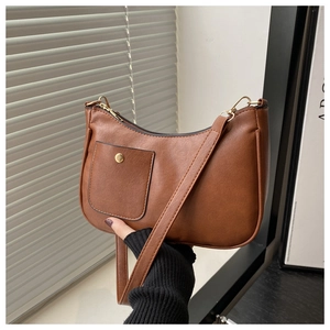Close-up of vintage brown square shoulder bag with smooth PU texture and gold hardware
