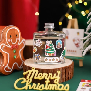 Christmas theme DIY sticker set with a clear flat glass bottle on a wooden base