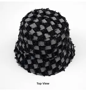 Top view of checkered bucket hat featuring frayed edges and woven fabric texture