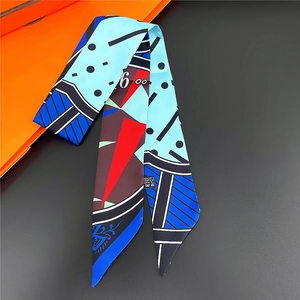 Silk-feel twilly scarf with abstract geometric patterns and polka dots on a dark background