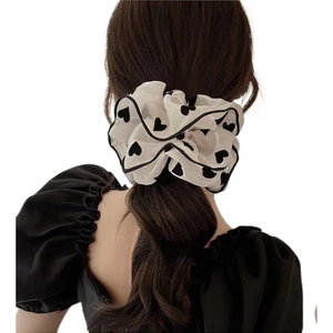 White heart print chiffon scrunchie shown on hair from a back view hairstyle perspective