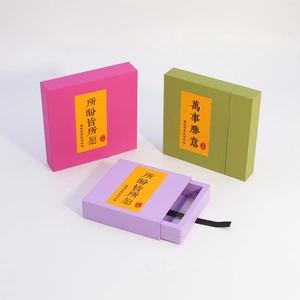 Detail of colorful drawer jewelry boxes with satin pull tabs and festive labels