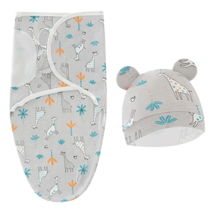 Detail of soft cotton baby swaddle wrap and matching hat with giraffe cartoon pattern