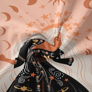 Detailed view of bohemian tapestry fabric with mystical moon and star illustration patterns