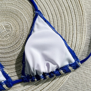 Detail of blue knit bikini top with soft white lining and lace-up drawstring