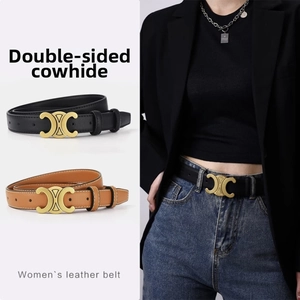 Detail of double-sided leather belt featuring a gold Triomphe buckle in black and brown