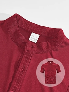 Detail of red men's polo shirt neckline with M size label and fine twill fabric texture