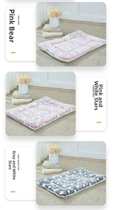 Detail of plush quilted pet mats in pink bear, pink star, and grey star patterns