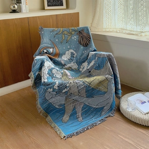 Bohemian style woven blanket with blue ocean motifs and tassels for outdoor camping