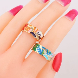 Detail of gold-plated enamel rings with colorful gradients and micro-set cubic zirconia