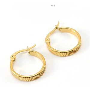 Detailed view of gold round snap hoop earrings with textured diagonal pattern etching