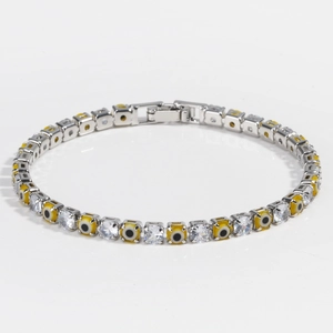 Detail showing 4mm silver tennis chain with yellow evil eye charms and cubic zirconia