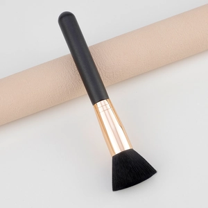 Multi-functional black powder brush with soft bristles and gold metal ferrule on prop