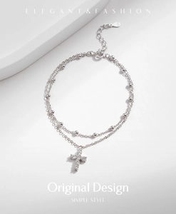 Detail of S925 sterling silver double-layer bracelet with cross pendant and round beads