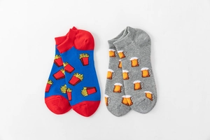 Flat lay of colorful cotton boat socks featuring French fries and beer mug patterns