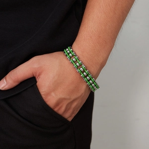 Detail of green and silver motorcycle chain bracelet worn on wrist for hip-hop style
