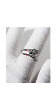 Detailed view of silver panther head ring with sparkling zircon and green gemstone eyes