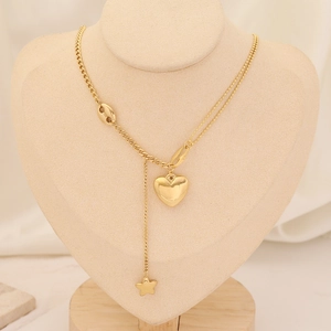 Detail of layered gold heart and star pendants on O-chain and bead chain necklace