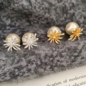 Elegant gold and silver firework pearl earrings with micro-set zircon accents on plush background