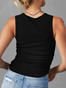 Close-up back view of a black ribbed knit tank top paired with denim jeans and necklace