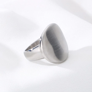Macro shot of silver stainless steel ring with brushed finish and polished edges