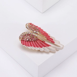 Detail view of crystal angel wing brooch with pink enamel finish and sparkling rhinestones