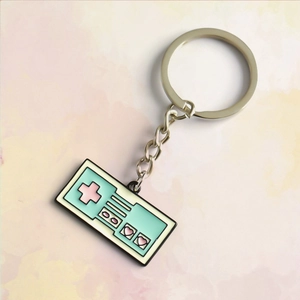 Detail of pixel heart game controller keychain with pastel enamel and silver metal ring