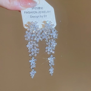 Detailed view of S925 silver needle dangling earrings with zircon flowers and tassels
