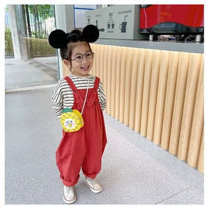 Toddler girl in red overalls with a cute yellow pineapple crossbody bag and mouse ears