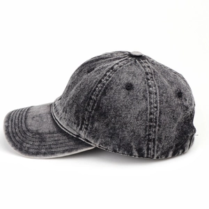 Macro side view of vintage washed denim baseball cap with acid wash texture and seams