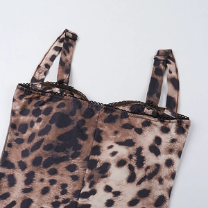 Detailed close-up of leopard print jumpsuit featuring black lace trim and adjustable straps