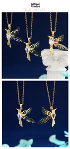 Macro shot of hummingbird pendant with heart crystal and iridescent gradient wing details