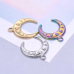 Three moon pendants in gold, silver and rainbow finish with embossed dots on light background