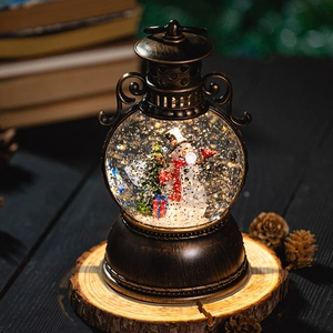 Vintage bronze Christmas lantern music box with snowman and glittery snow globe effect