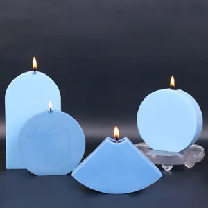 Finished pastel blue geometric candles made from silicone molds on a dark gradient background