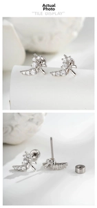 Detail of silver bow cartilage stud earring with micro-paved cubic zirconia and screw back