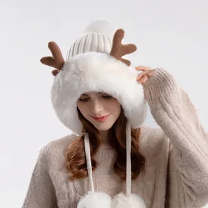 Winter plush earflap hat with brown antlers and large white pom-poms for women